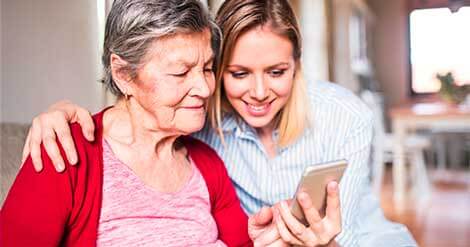 Reach-us old women holding phone with a girl