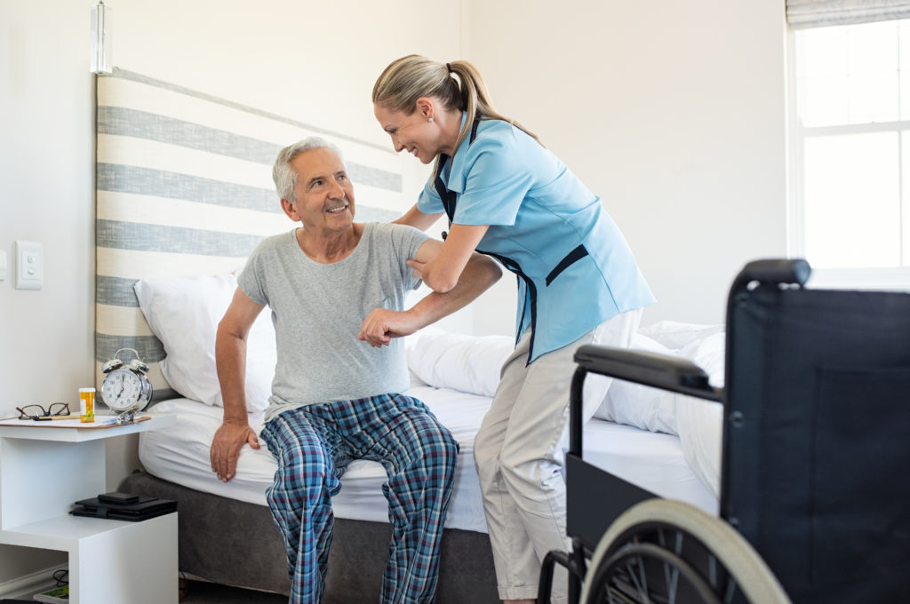 in-home caregiver assisting an elderly patient
