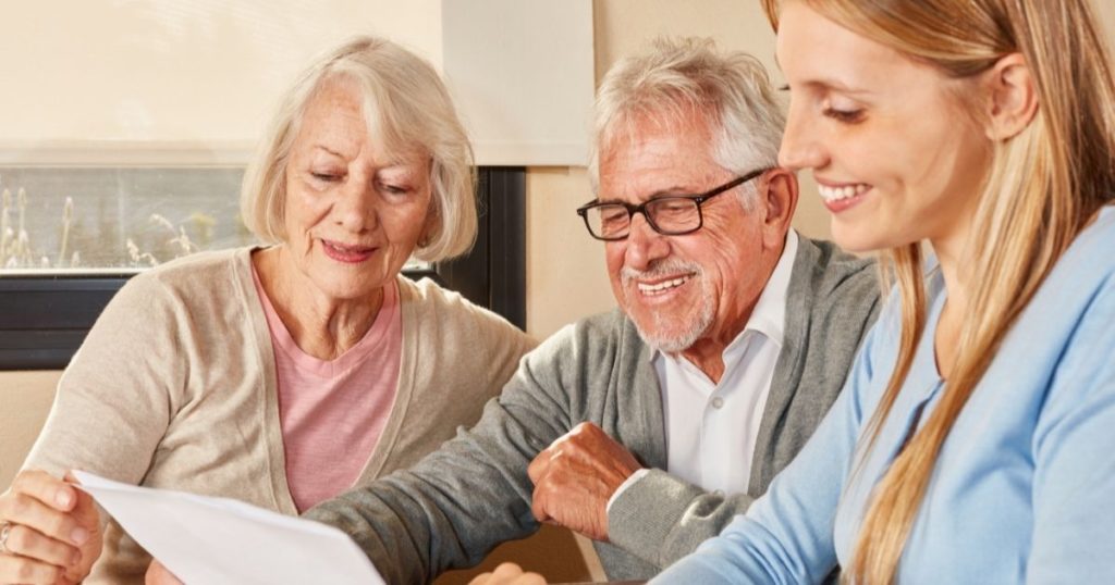A daughter sits down to help her senior parents with their finances.
