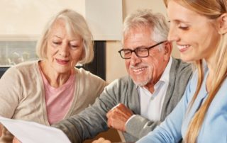 A daughter sits down to help her senior parents with their finances.