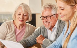 A daughter sits down to help her senior parents with their finances.