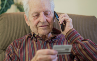 Man-giving-card-information-Senior-Fraud-Prevention