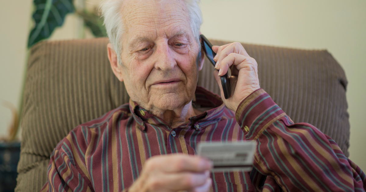 Man-giving-card-information-Senior-Fraud-Prevention