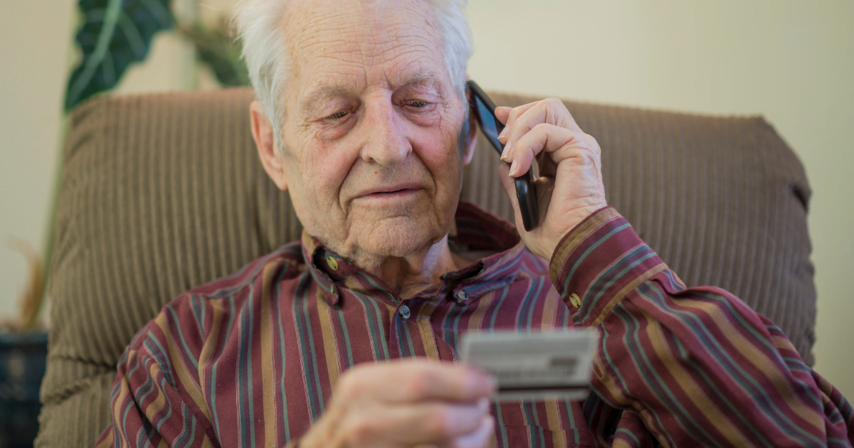 Man-giving-card-information-Senior-Fraud-Prevention.