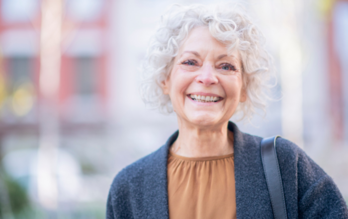 A woman is happy thanks to following good senior incontinence management practices.