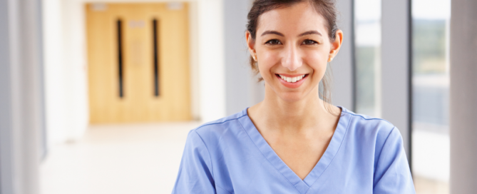 A caregiver looks happy as she looks forward to her career in home care.