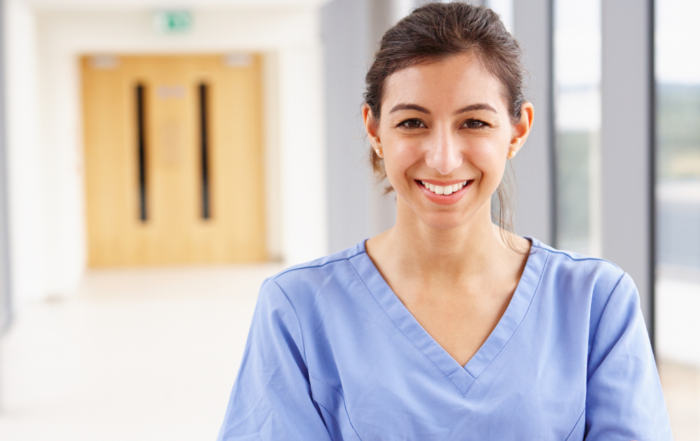 A caregiver looks happy as she looks forward to her career in home care.