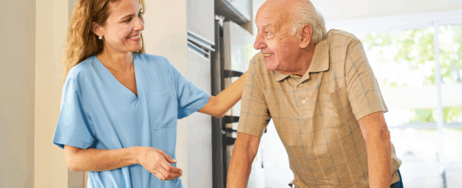 Caregiver smiling at senior man using a walker.