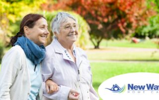 A recently retired woman enjoys her caregiving job as she walks with a senior client outside.