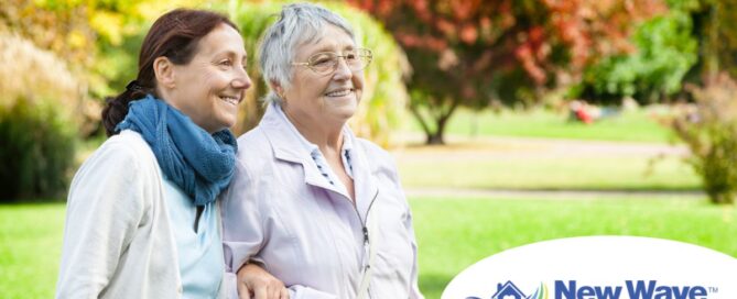 A recently retired woman enjoys her caregiving job as she walks with a senior client outside.