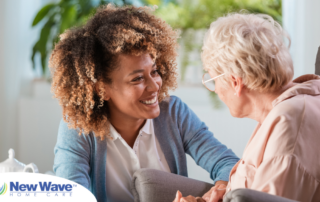 A woman enjoys compassionately providing caregiving services to an elderly woman.