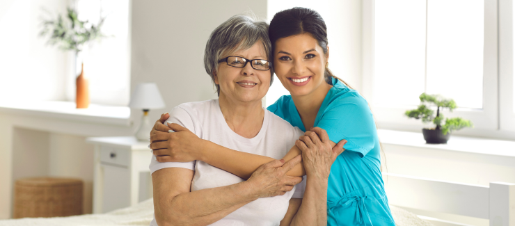 A professional caregiver hugging a senior client represents quality dementia care in Los Angeles.