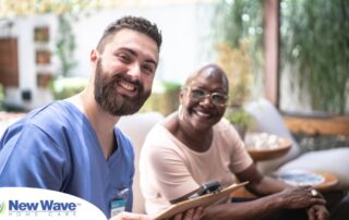 A man enjoys his caregiver job as he works with a client.