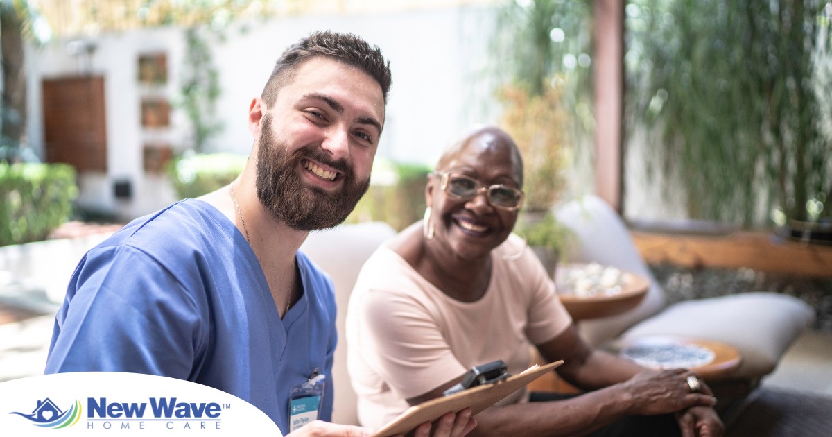 A man enjoys his caregiver job as he works with a client.