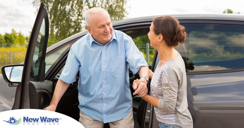 A caregiver helps a senior carefully get out of the care, representing the safety that those who work in home care should strive for.