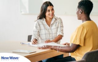 A woman smiles while being interviewed representing how well a caregiver interview can go when good questions are asked.