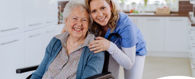 A caregiver enjoys her job as she smiles with a happy client representing the joy that can come from a home care career.