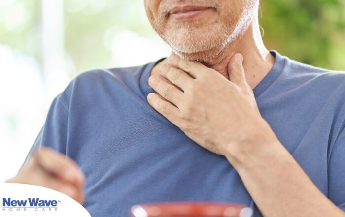 An older adult holds his throat representing dysphagia which can affect senior health.