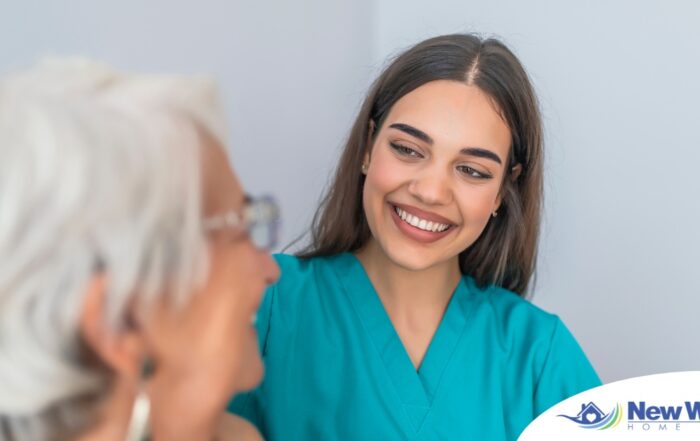 A caregiver smiles with an older client showing the results of successfully starting a new caregiving job.