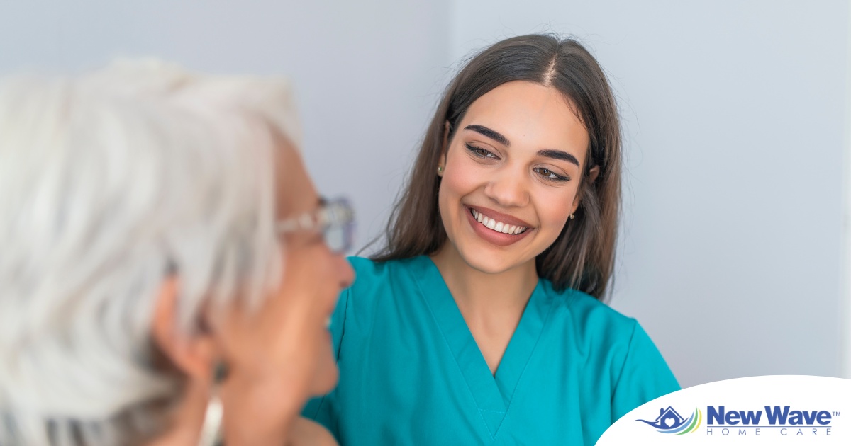 A caregiver smiles with an older client showing the results of successfully starting a new caregiving job.