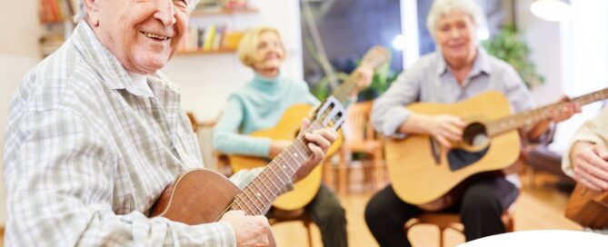 A group of seniors enjoy playing instruments together showing the impact of music for older adults.