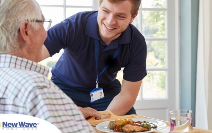 Professional caregiving involves helping clients with iADLs and ADLs as demonstrated by this caregiver helping a client by bringing a meal.