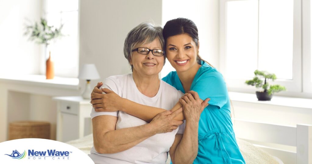 A caregiver hugs an older client, representing how a trustworthy caregiver cares for clients.