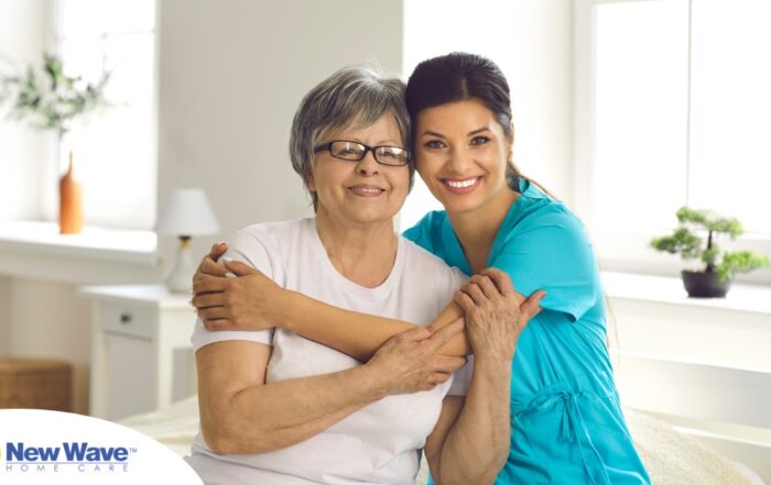 A caregiver hugs an older client, representing how a trustworthy caregiver cares for clients.
