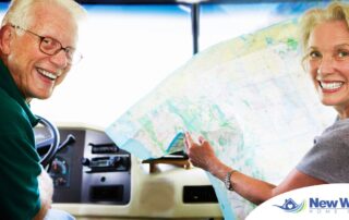 An older couple looks back smiling from the front of an RV, representing how day trips for seniors can help boost the mood of everyone.