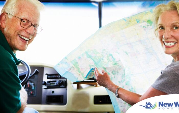 An older couple looks back smiling from the front of an RV, representing how day trips for seniors can help boost the mood of everyone.