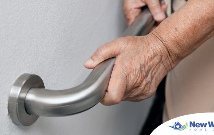 An older adult uses a grab bar representing one of the home modifications that is helpful for fall prevention for elderly adults.
