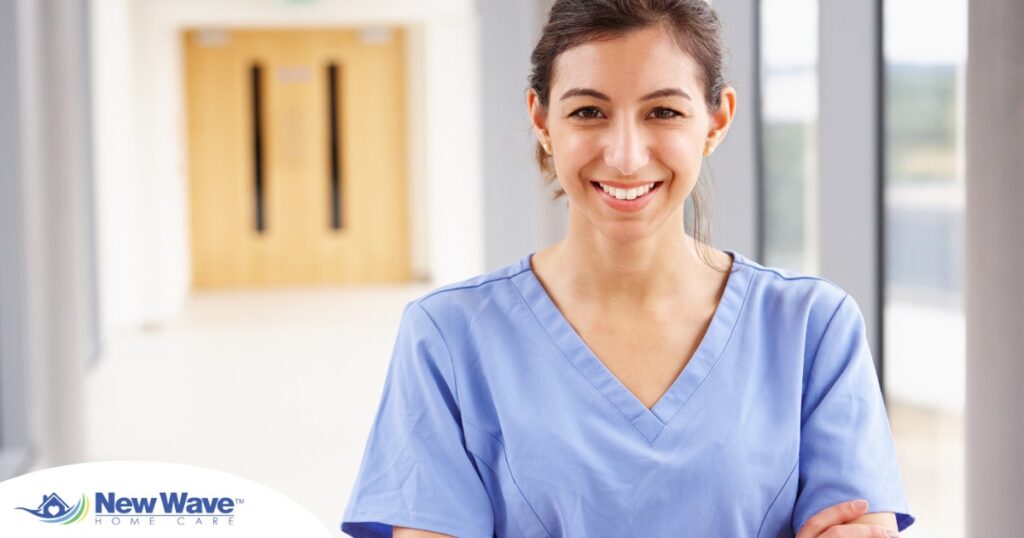 A woman in scrubs smiles, representing the good results that can come when caregivers branch out to become CNAs.