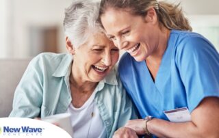A woman in scrubs laughs with a senior woman, representing how caregiving can be a great career choice.