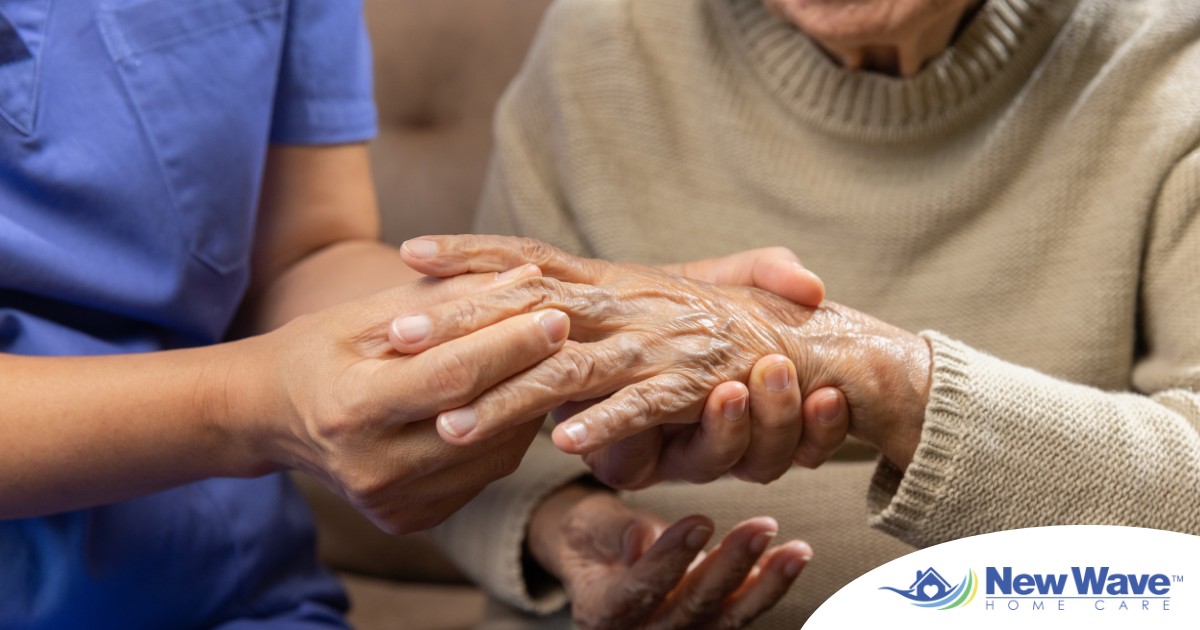 A care provider examines an older adult’s fingers, representing what would happen in an examination for rheumatoid arthritis.