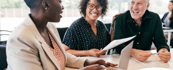 A couple talks with and advisor, representing the type of preparation that is crucial for successful senior care planning.