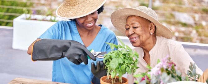 Caregiver and Senior gardening as part of companion care activities.