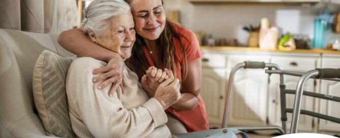Caregiver supporting an elderly woman in the transition to senior home care