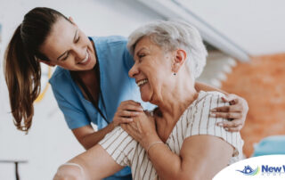 A female caregiver helping an older woman with stroke recovery at home.