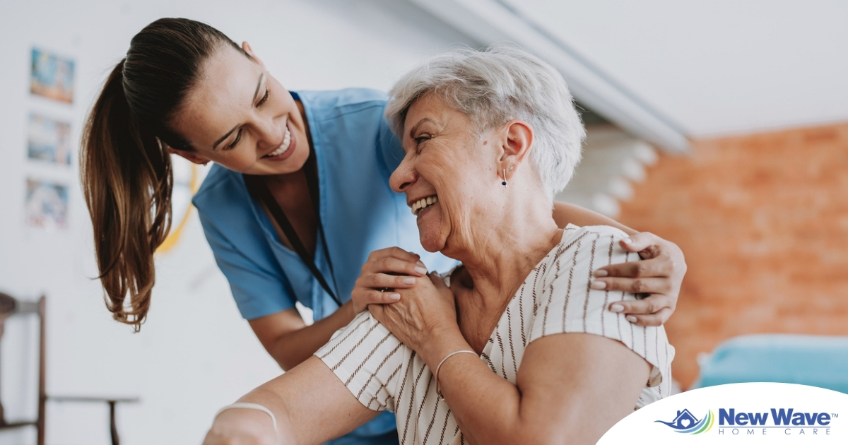 A female caregiver helping an older woman with stroke recovery at home.